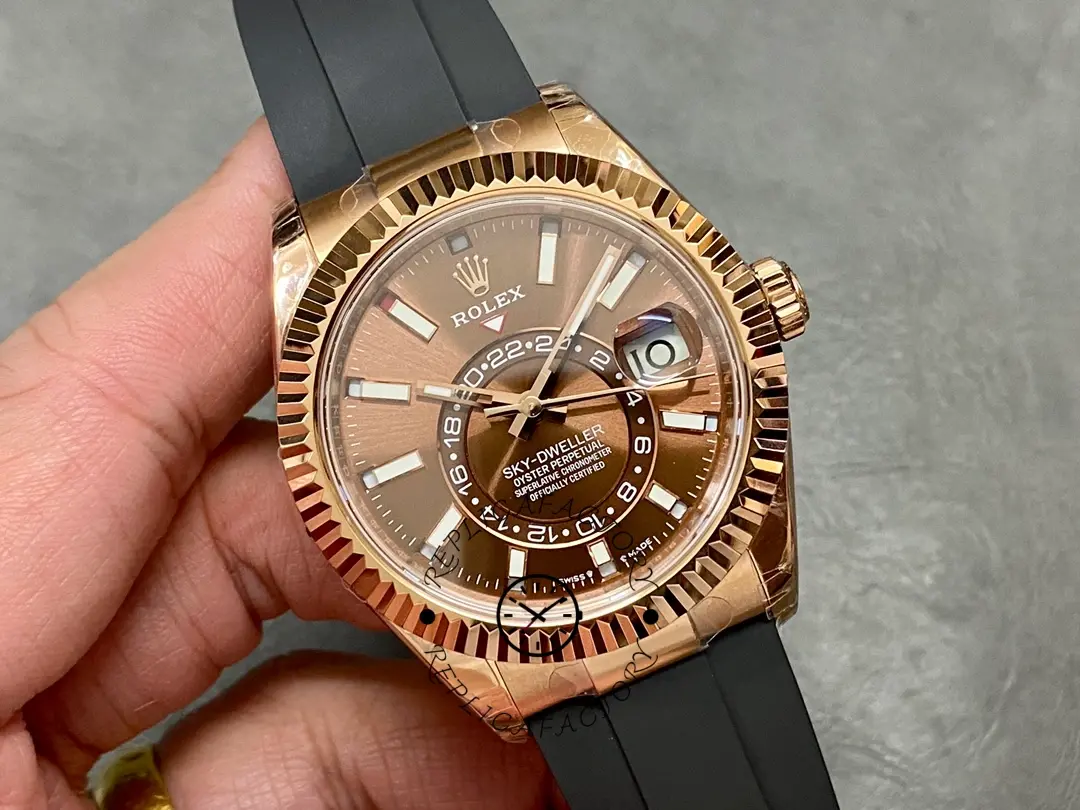 Handheld angled view of Rolex Sky-Dweller m336235 0002, highlighting rose gold case and bezel.