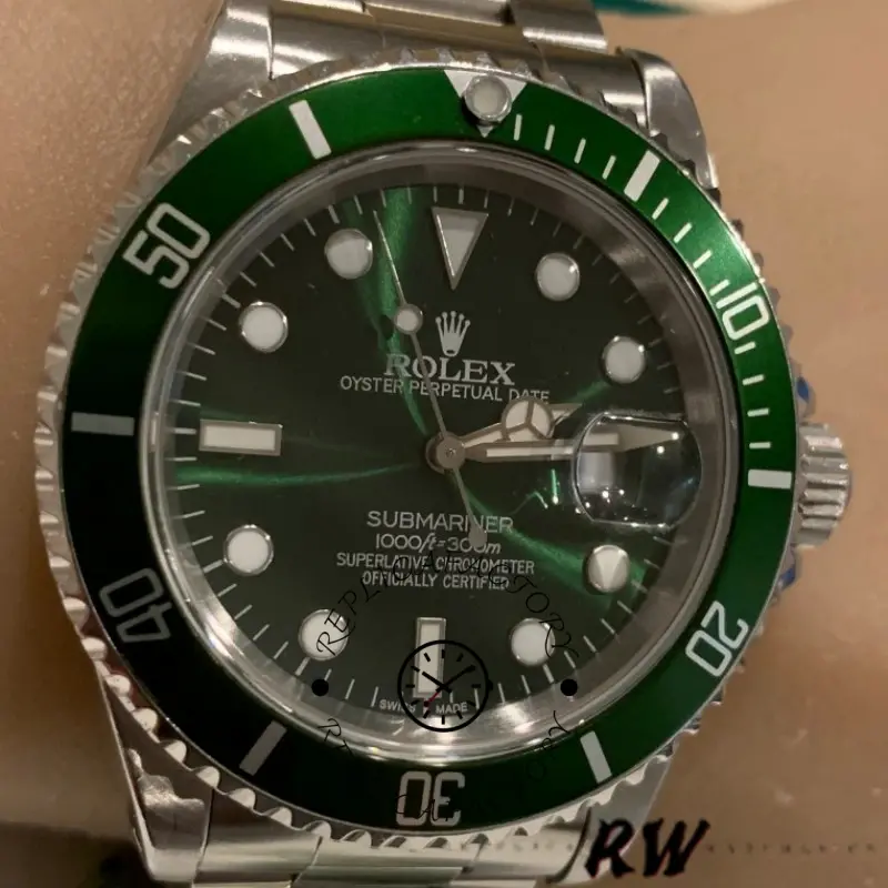 Rolex Submariner 16610, dial close-up showing green dial and minute markers.
