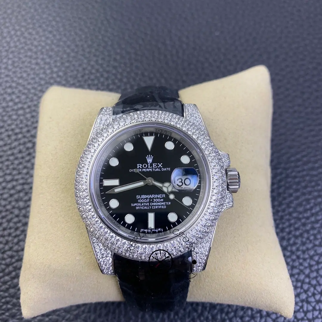 Rolex Submariner 116610, pillow display showing diamond bezel and black dial.