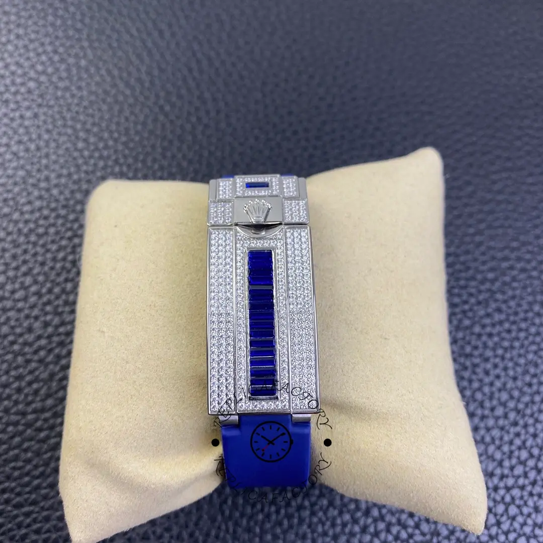 Bracelet/strap view of Rolex Submariner 116610 showing blue rubber strap section and clasp area on pillow.