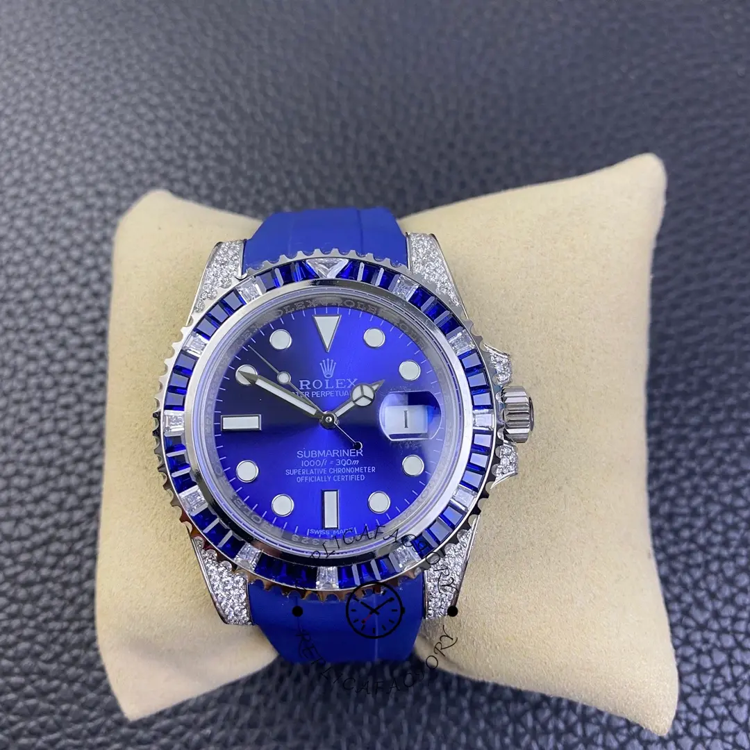 Rolex Submariner 116610 on pillow, full watch view with blue dial, luminous markers, and diamond-set case.