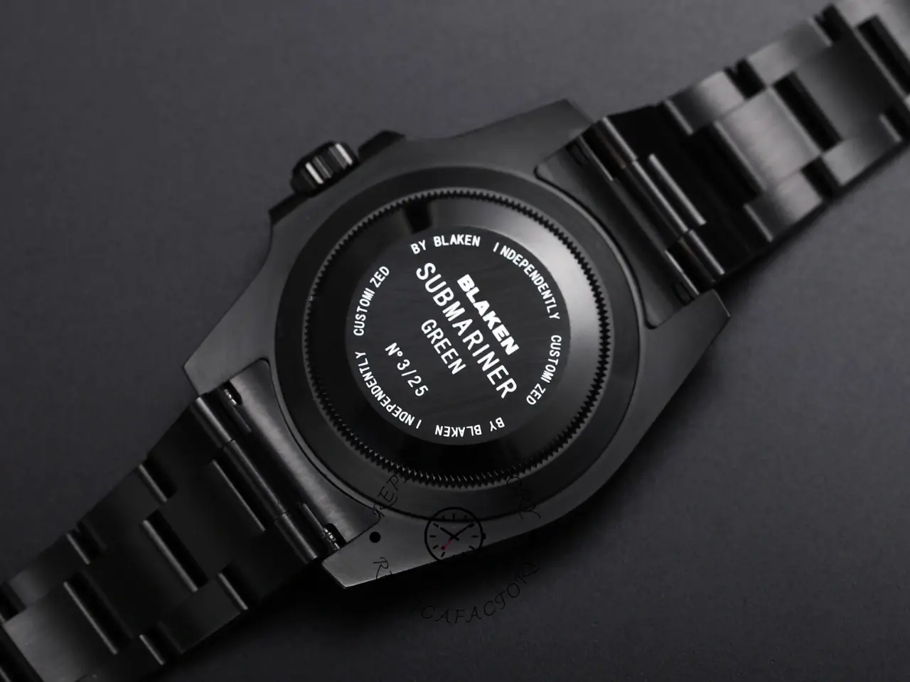 Caseback view of Rolex Submariner 116610LV showing engraved back and black bracelet end links.