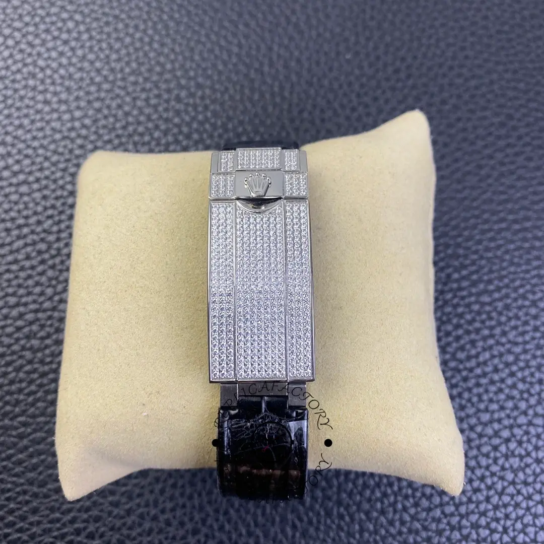 Rolex Submariner 116610, strap view on pillow showing black band texture.