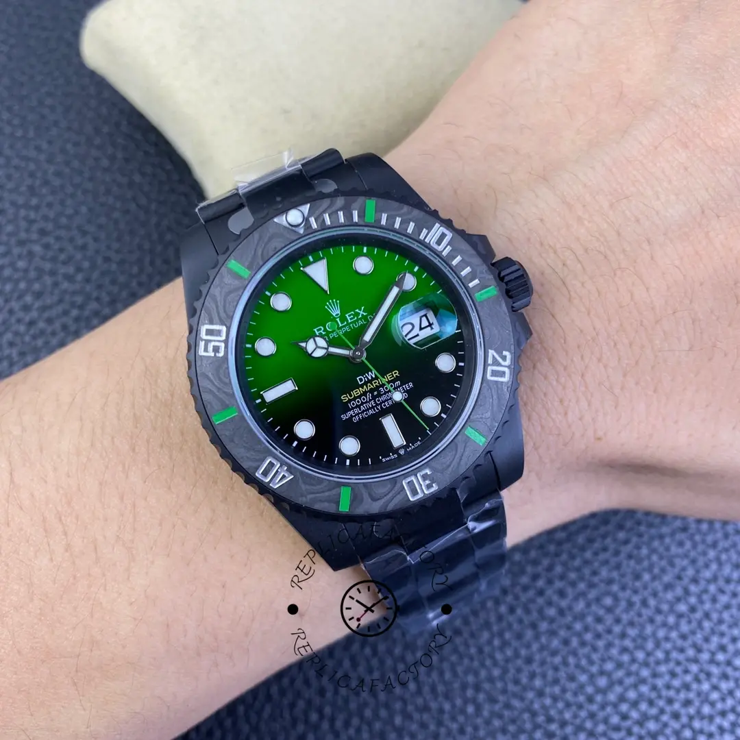 Wrist shot of Rolex Submariner 116610LV showing green dial and black strap on wrist.