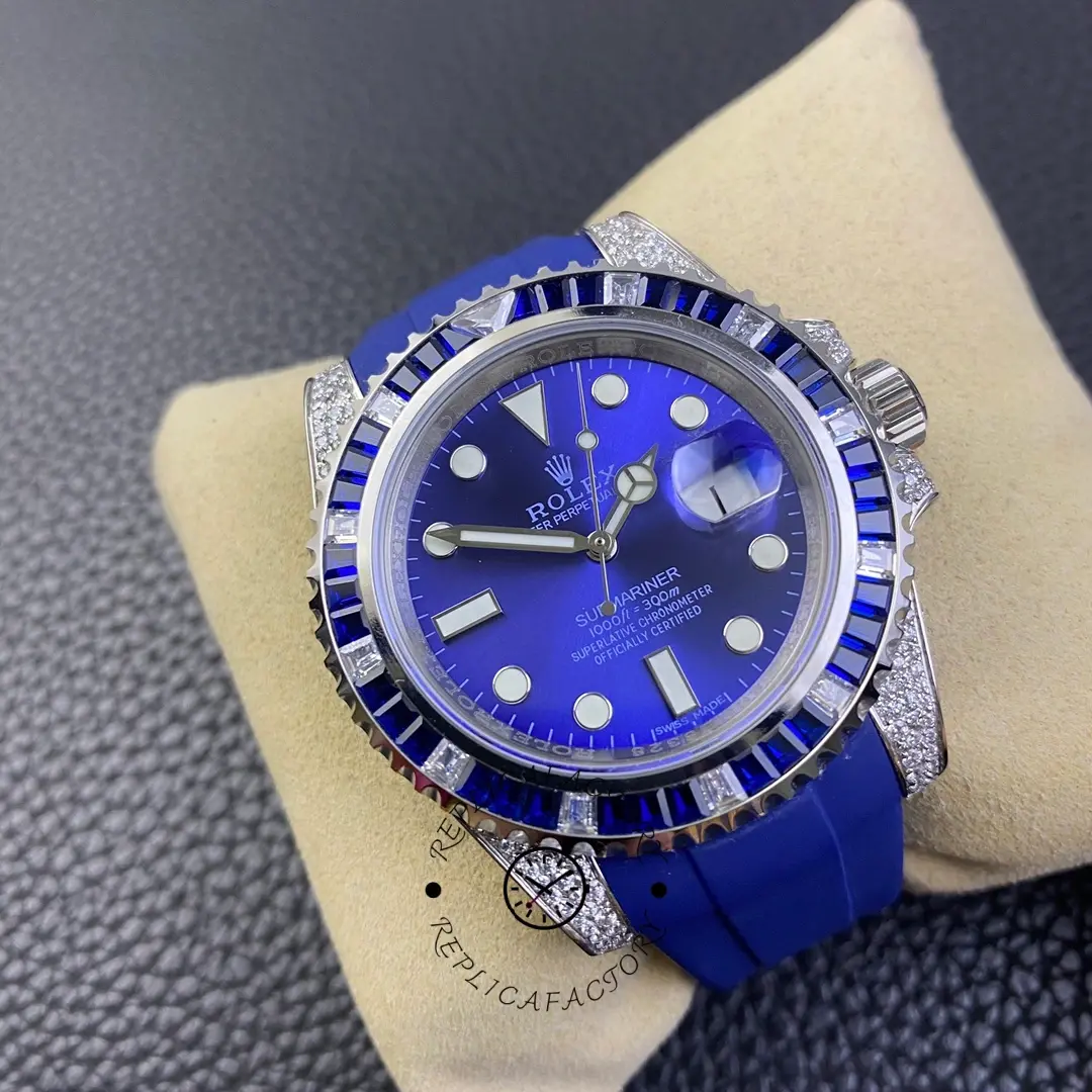 Angled pillow view of Rolex Submariner 116610 showing blue dial, Cyclops date, and diamond-set case edge.