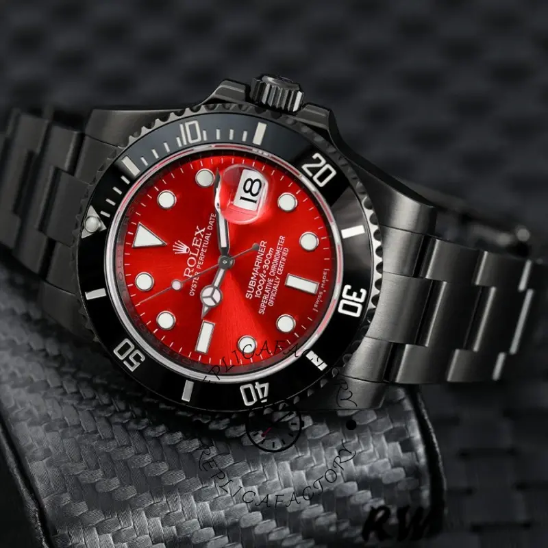 Rolex Submariner Date 116610LN on bracelet, red dial centered, black PVD/DLC links visible.