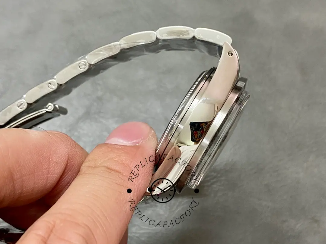 Rolex Daytona 6265, side view focusing on the pushers with blue protective film and polished case flank.