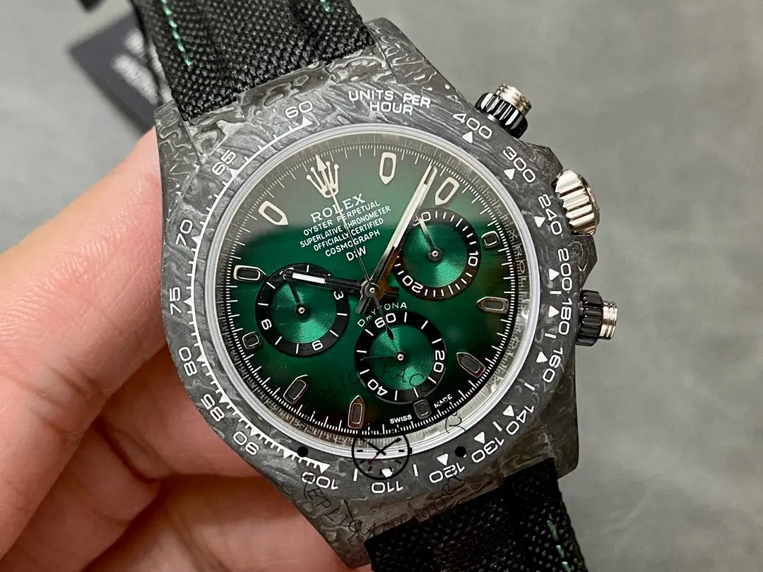 Rolex Daytona DIW 40mm, close dial view with green chronograph subdials and luminous markers.