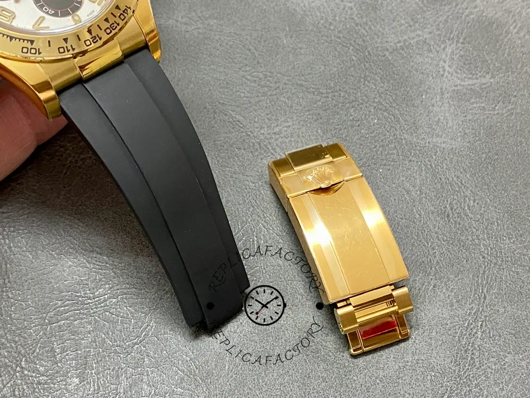 Rolex Daytona 116518, rubber strap end with folding clasp shown next to the watch.
