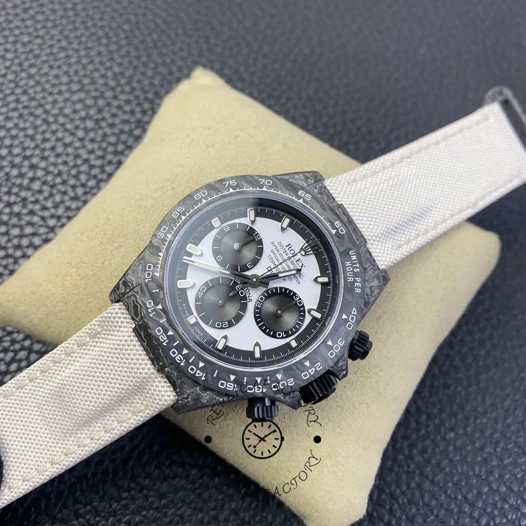Rolex Daytona DIW Carbonfiber 40, tilted front view showing case shape and strap texture.