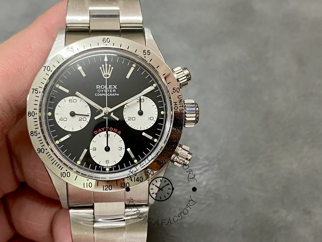 Rolex Daytona 6265, close-up front view in hand, black dial and tri-compax subdials.