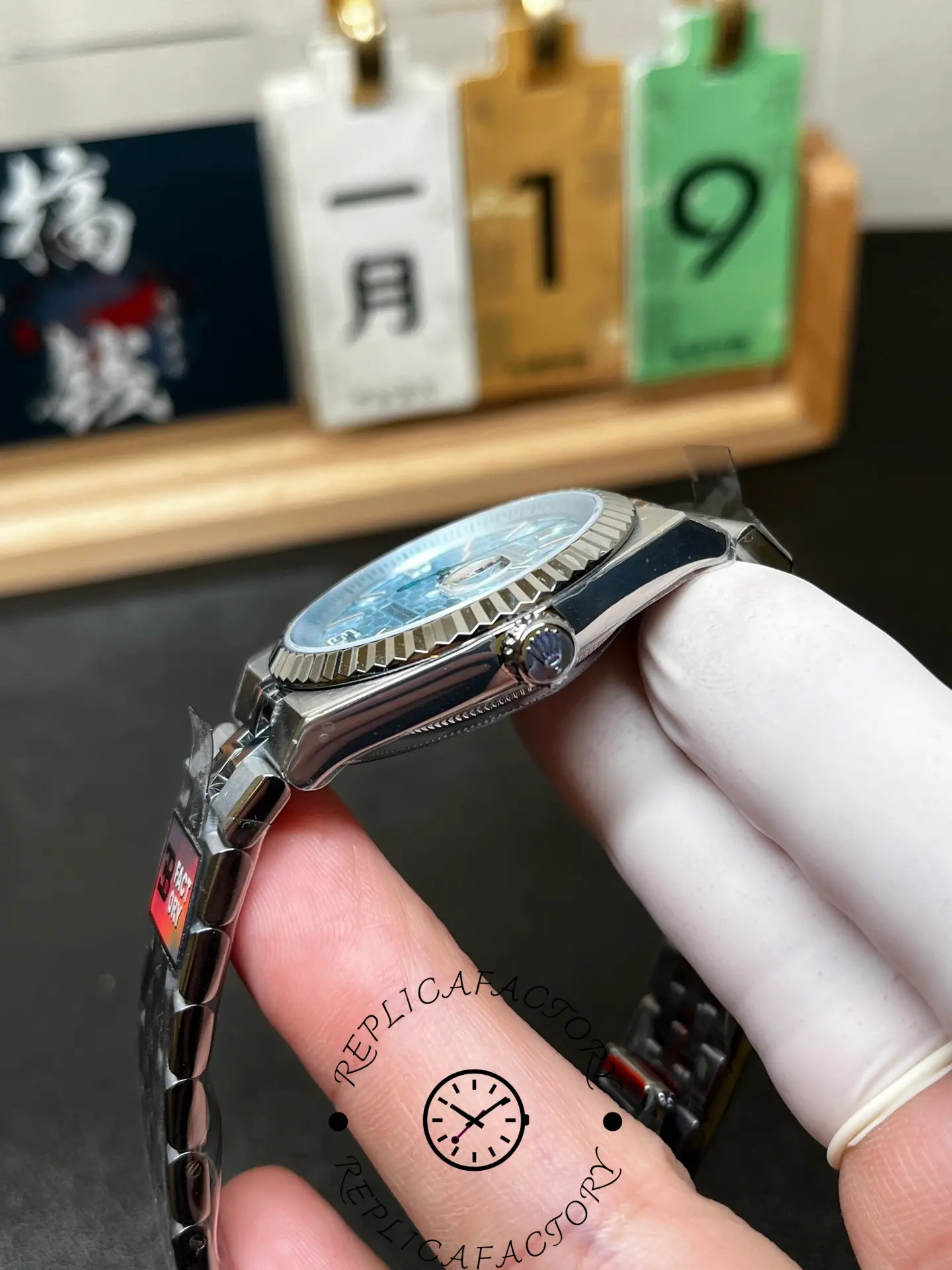 Crown-side view of Rolex Land-Dweller 36 m127236-0001 showing the signed crown and fluted bezel profile.