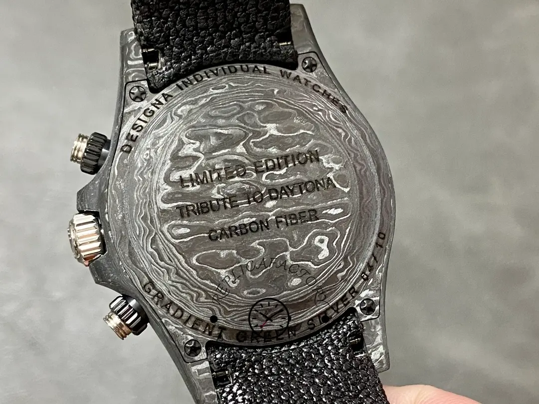 Rolex Daytona DIW 40mm, caseback close-up showing engraved back and lugs on black strap.