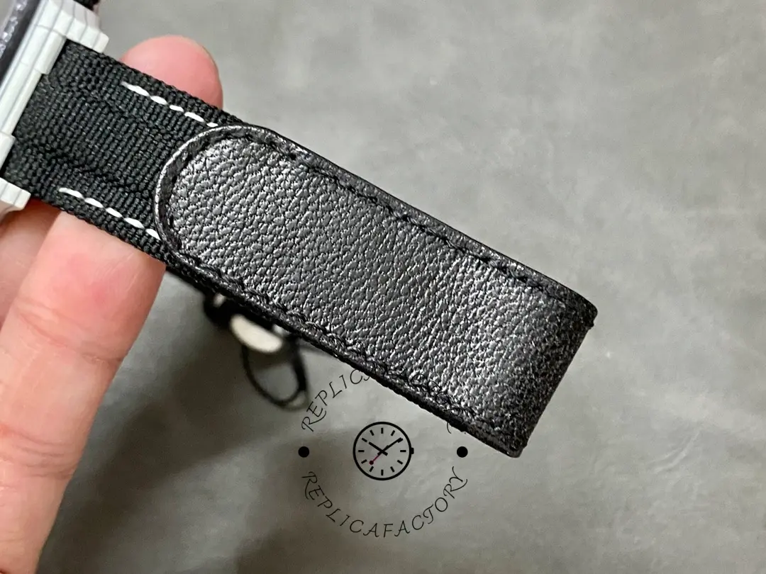 Clasp and strap underside of Rolex Daytona Cosmograph 40mm, showing stitching and buckle hardware.