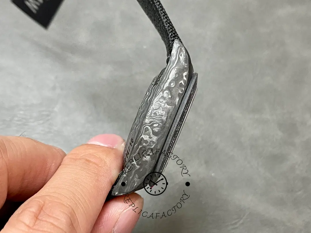 Rolex Daytona DIW 40mm, curved strap close-up showing fabric texture and case.