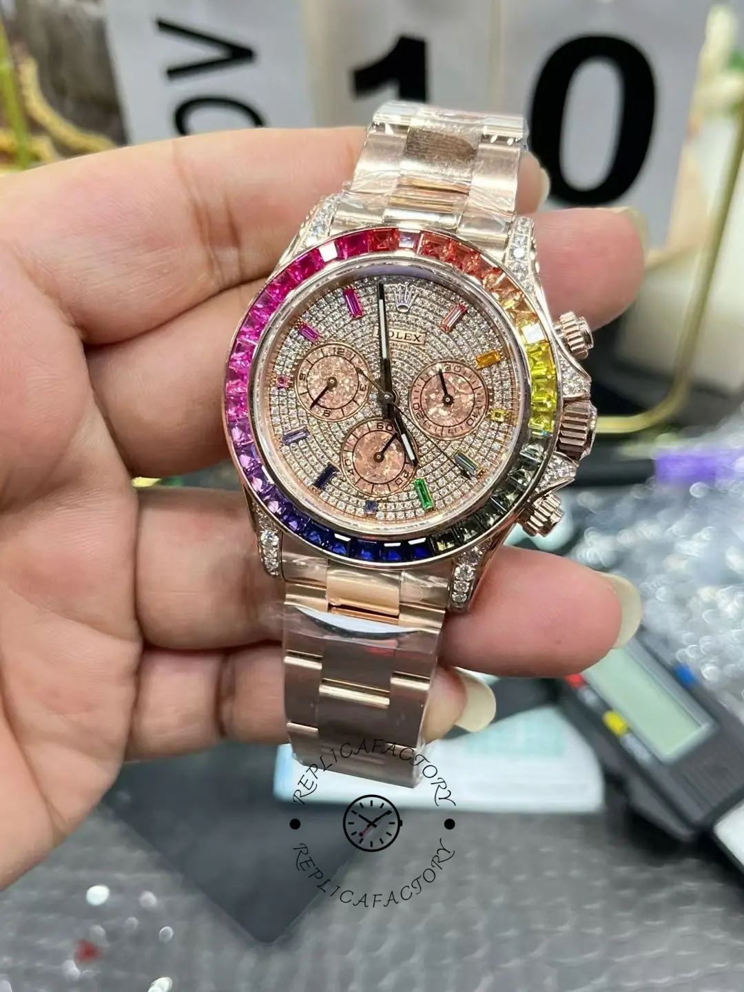 Rolex Daytona 116595RBOW close handheld shot, pavé dial and chronograph subdials, rainbow bezel.