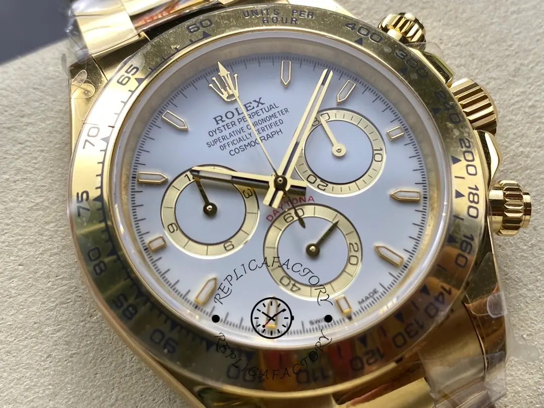 Dial close-up of Rolex Daytona 126508-0001 showing white dial, subdials, and gold hands.