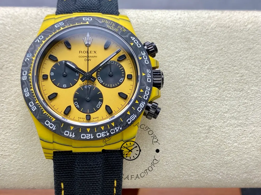 Rolex Daytona DIW, full watch on cushion showing yellow dial, black subdials, and tachymeter bezel.