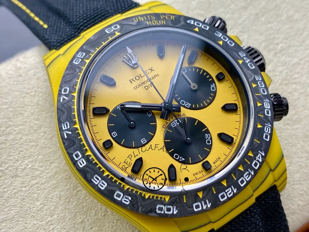 Rolex Daytona DIW, dial close-up highlighting the yellow face, black subdials, and luminous hour markers.