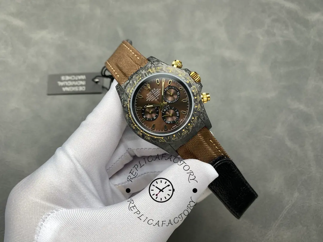 Hand-held full front view of Rolex Daytona DiW Black Gold showing carbon case profile.