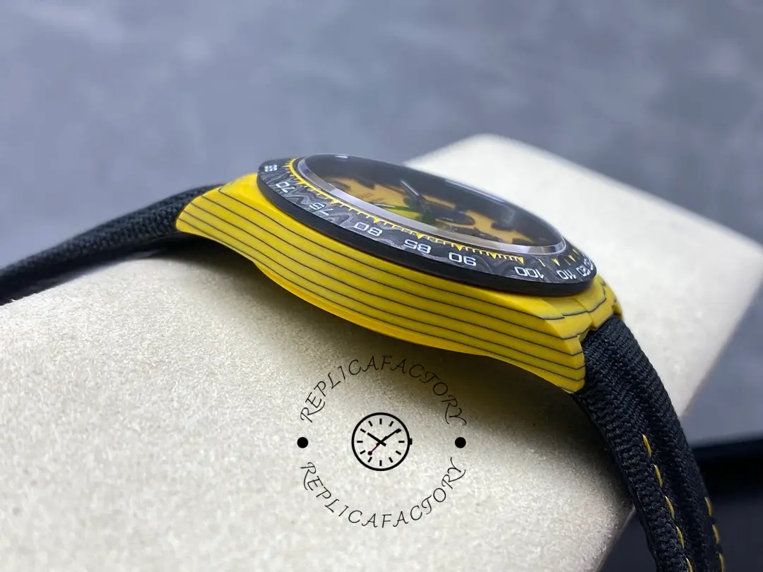 Rolex Daytona DIW, side-on view showing the case thickness and bezel lip above the yellow carbon case.