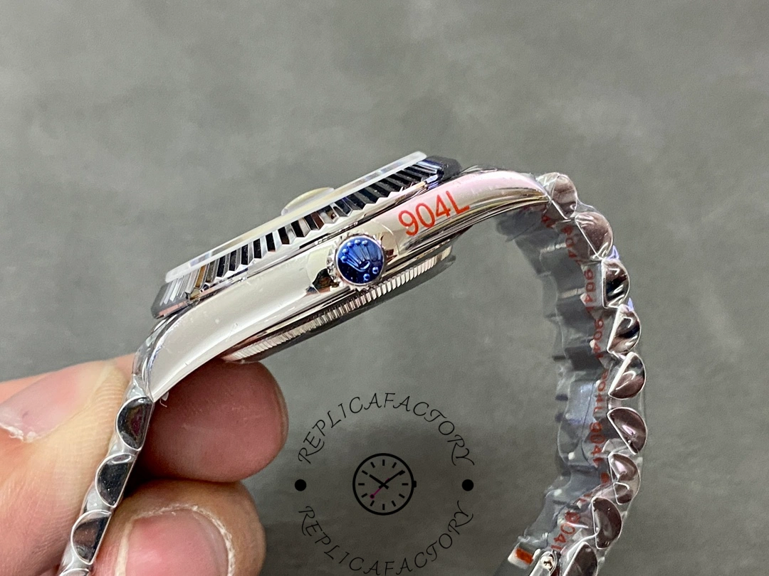 Side view of Rolex Day-Date 228239 showing fluted bezel edge and screw-down crown with blue sticker.