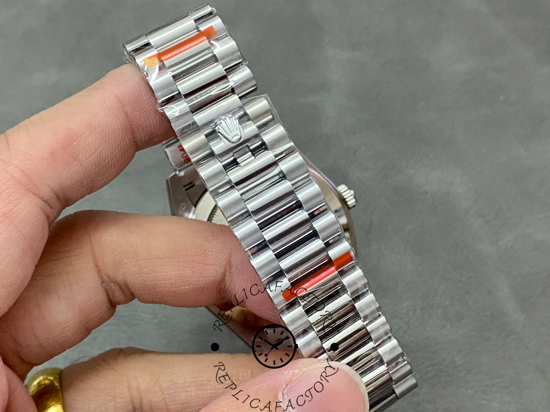 Bracelet clasp close-up of Rolex Day-Date 228239 showing Rolex crown logo on the clasp.