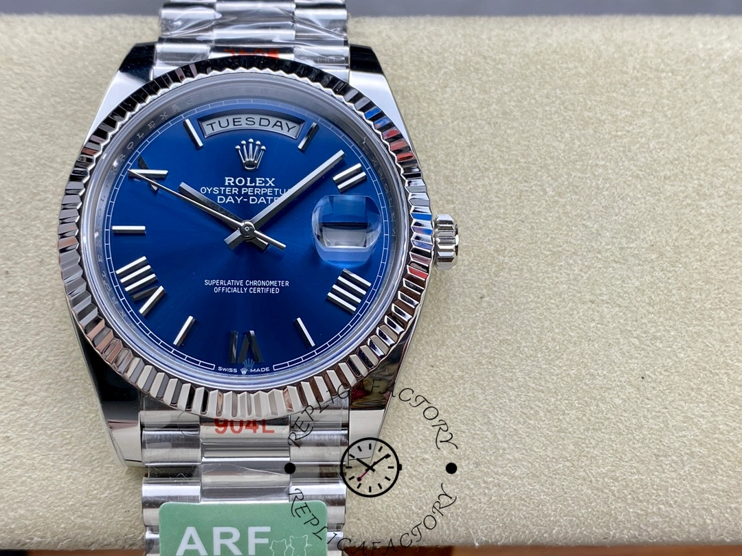 Rolex Day-Date 228239 on cushion showing blue dial, fluted bezel, day window and cyclops date lens.