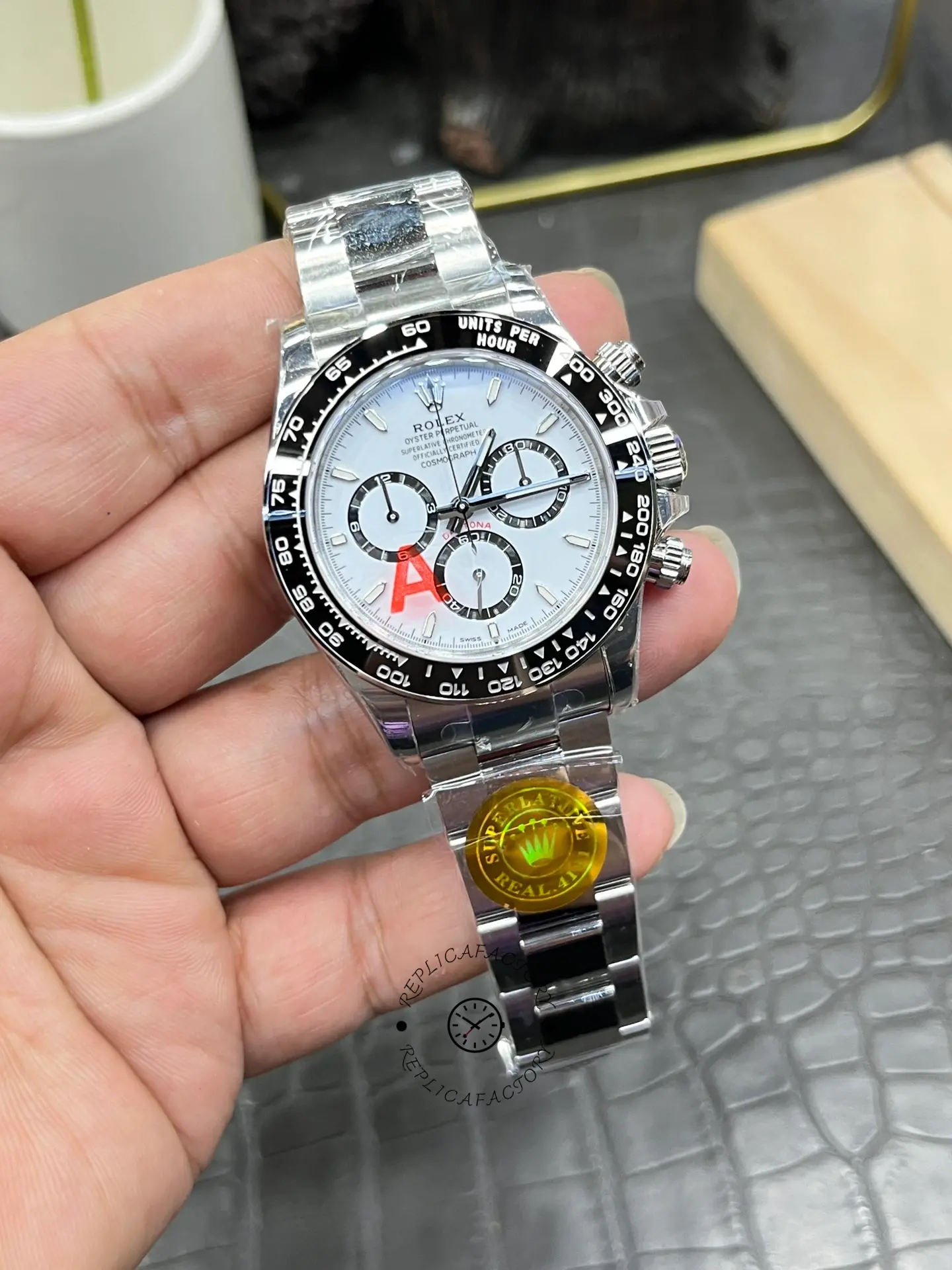 Rolex Daytona M126500LN-0001 handheld close-up, white dial and black subdials in focus.