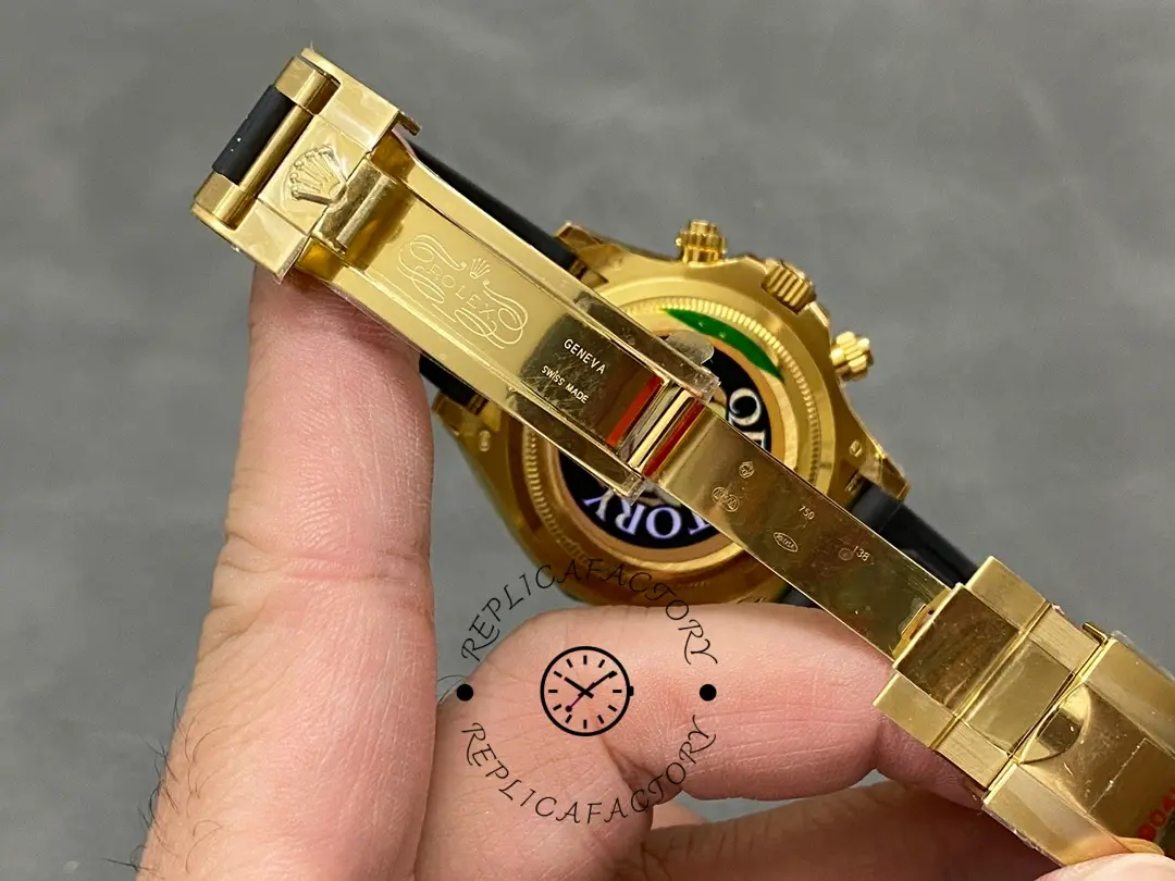 Rolex Daytona 126518LN strap and clasp view in hand, gold folding clasp detail.