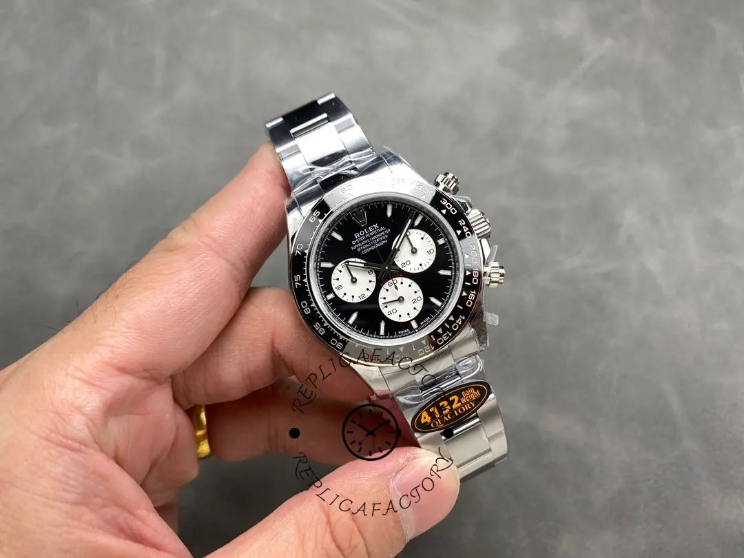 Full watch in-hand view of the Rolex Daytona 126529LN 40MM with steel bracelet and black bezel.