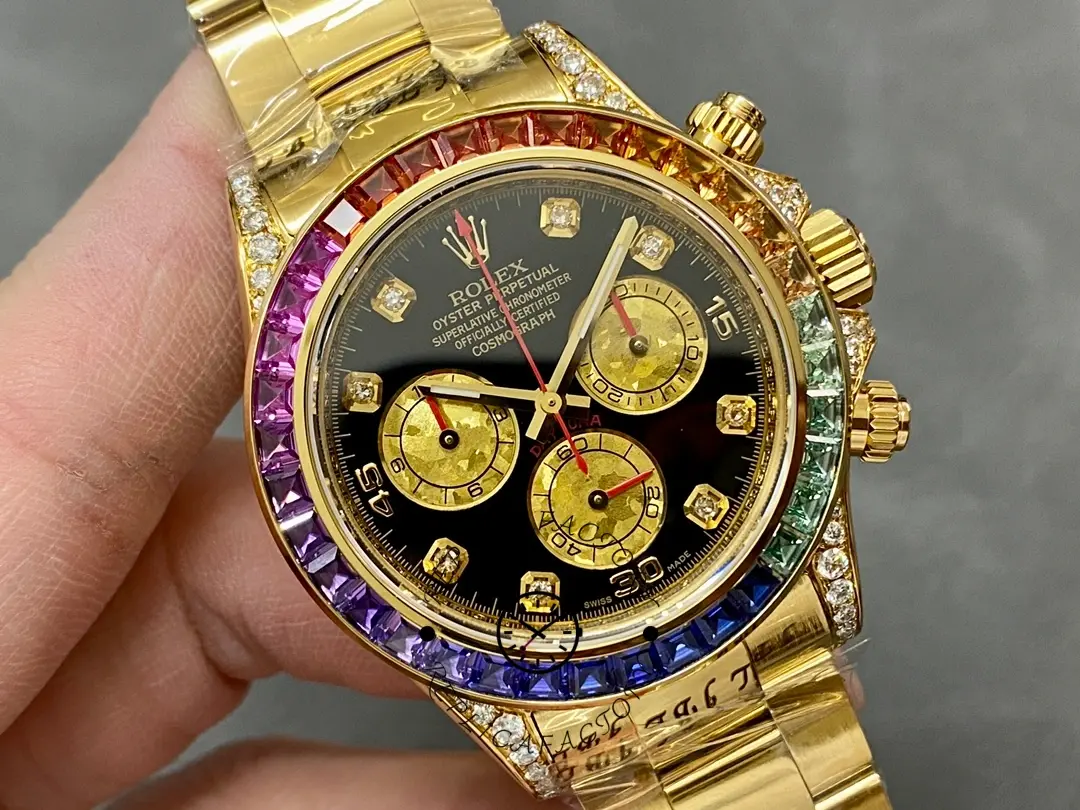 Hand-held close-up of the Rolex Daytona 116598 40MM highlighting gold subdials and bezel colors.