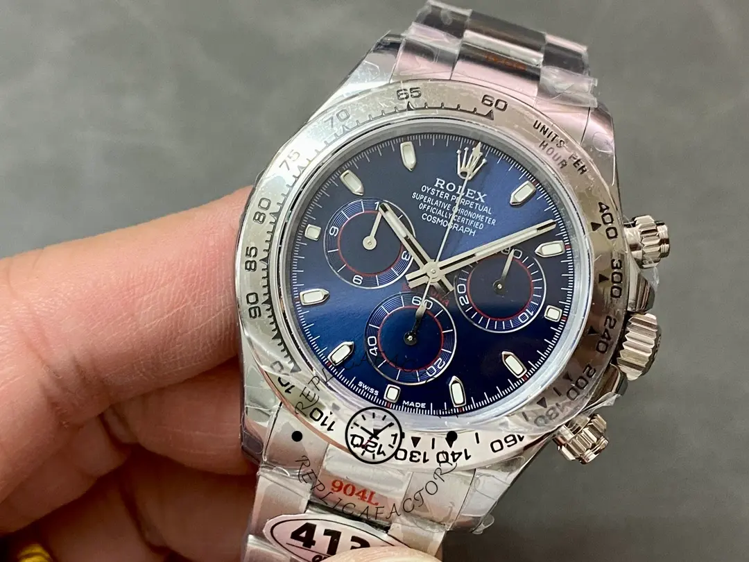 Hand-held close view of the Rolex Cosmograph Daytona 116509 40MM showing blue dial and subdials.