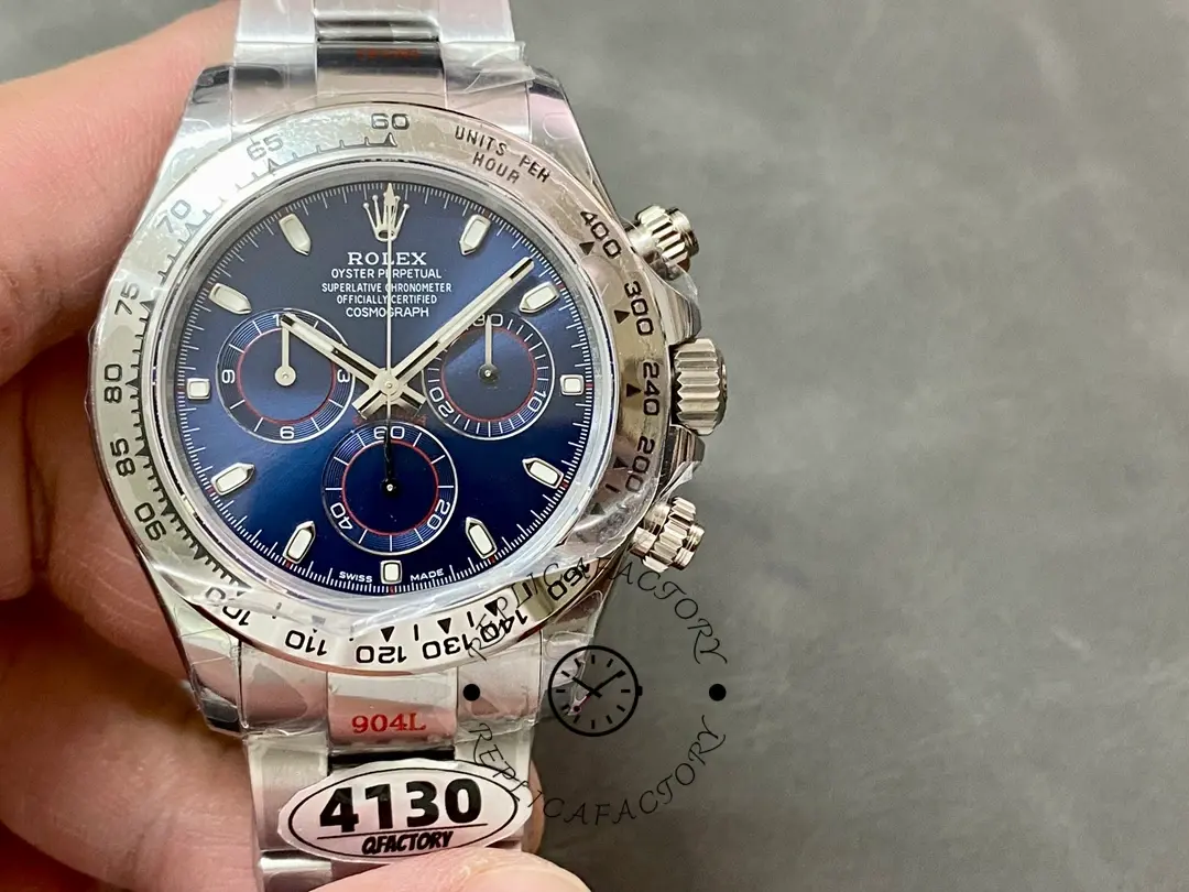 Hand-held front view of the Rolex Cosmograph Daytona 116509 40MM, blue dial with hang tag.