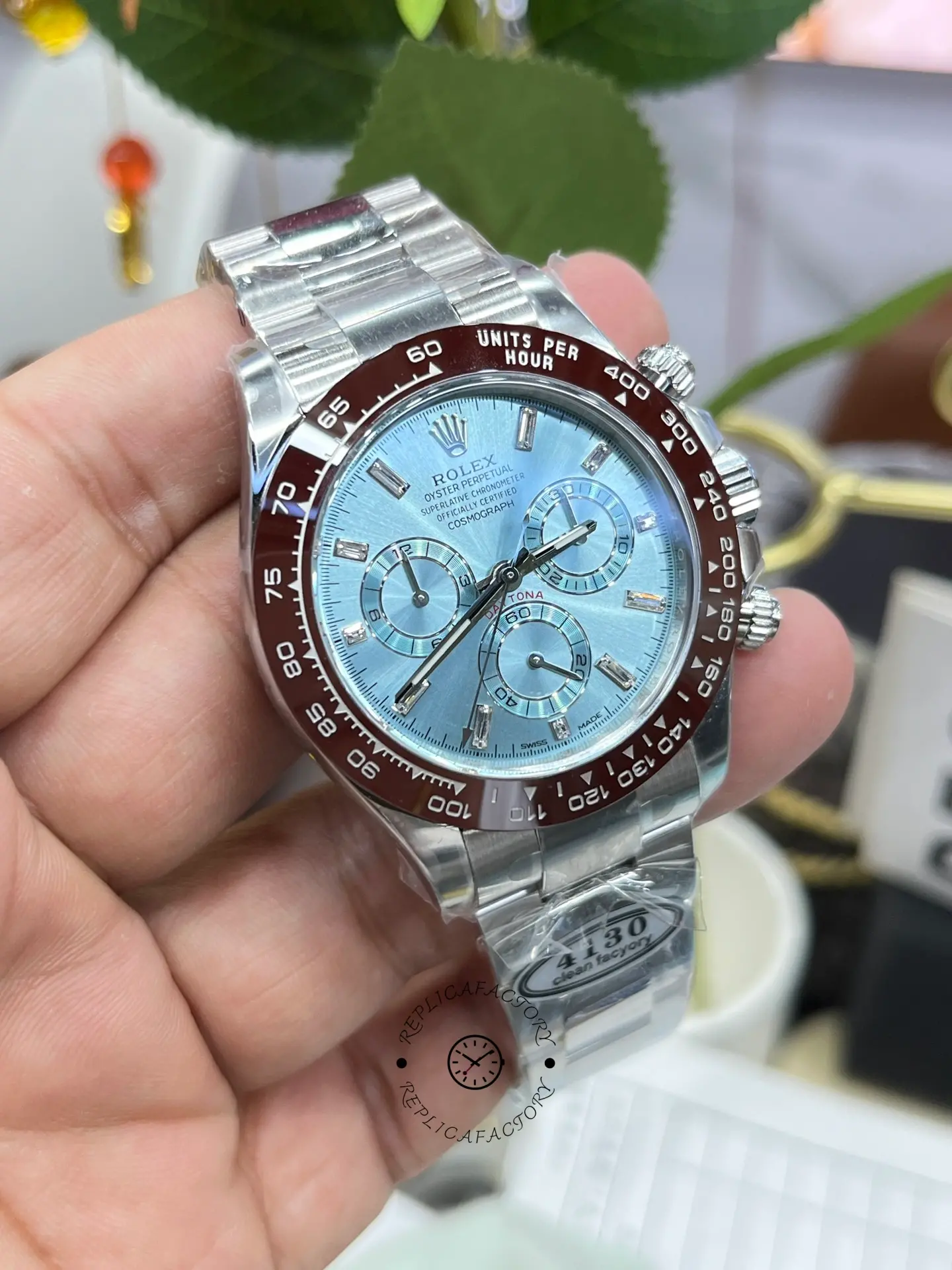 Handheld angled view of Rolex Daytona 116506 showing bezel markings and crystal.