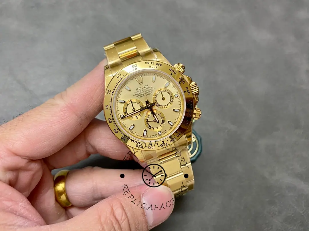 Rolex Daytona 116508 handheld full view, gold case and bracelet shown.