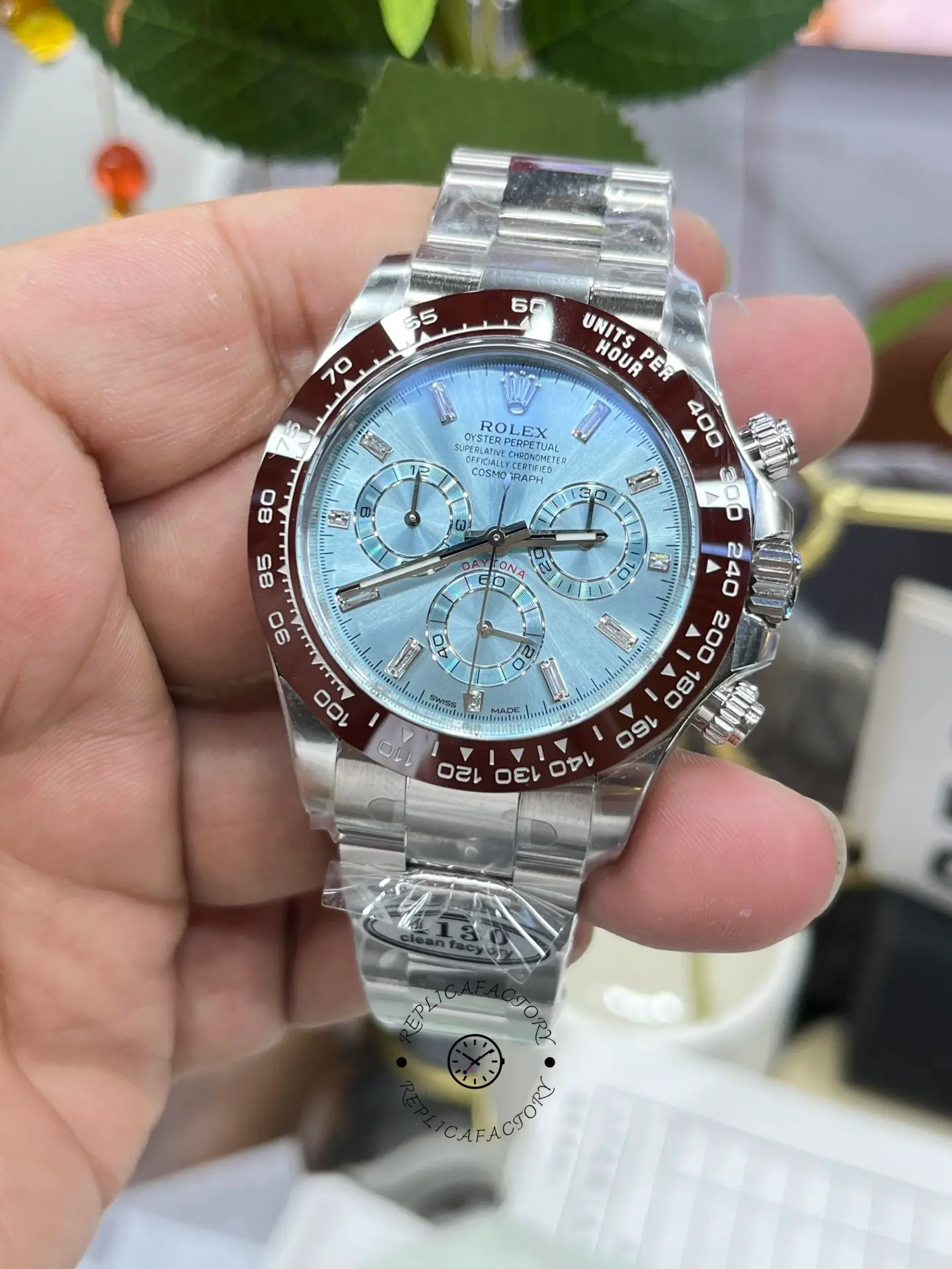 Handheld close-up of Rolex Daytona 116506 highlighting subdials and markers.