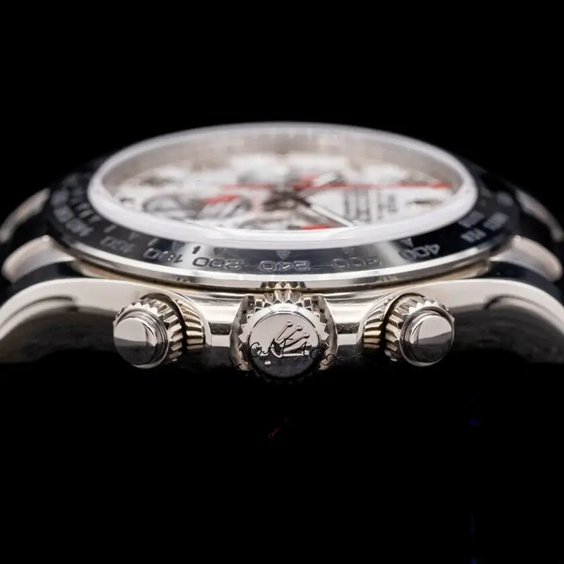 Low-angle close-up of Rolex Daytona 116519 showing bezel profile and pushers detail.