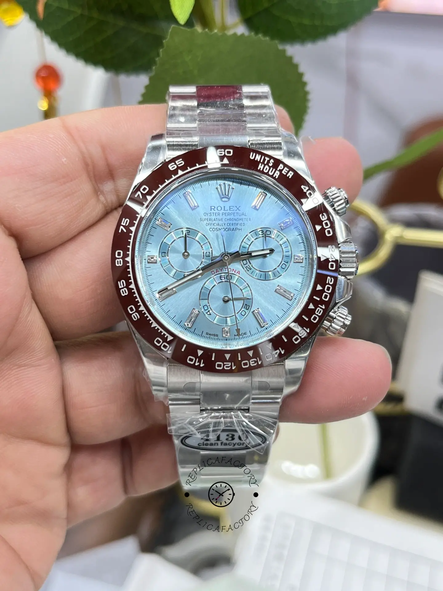 Handheld front view of Rolex Daytona 116506 showing dial details and bracelet.