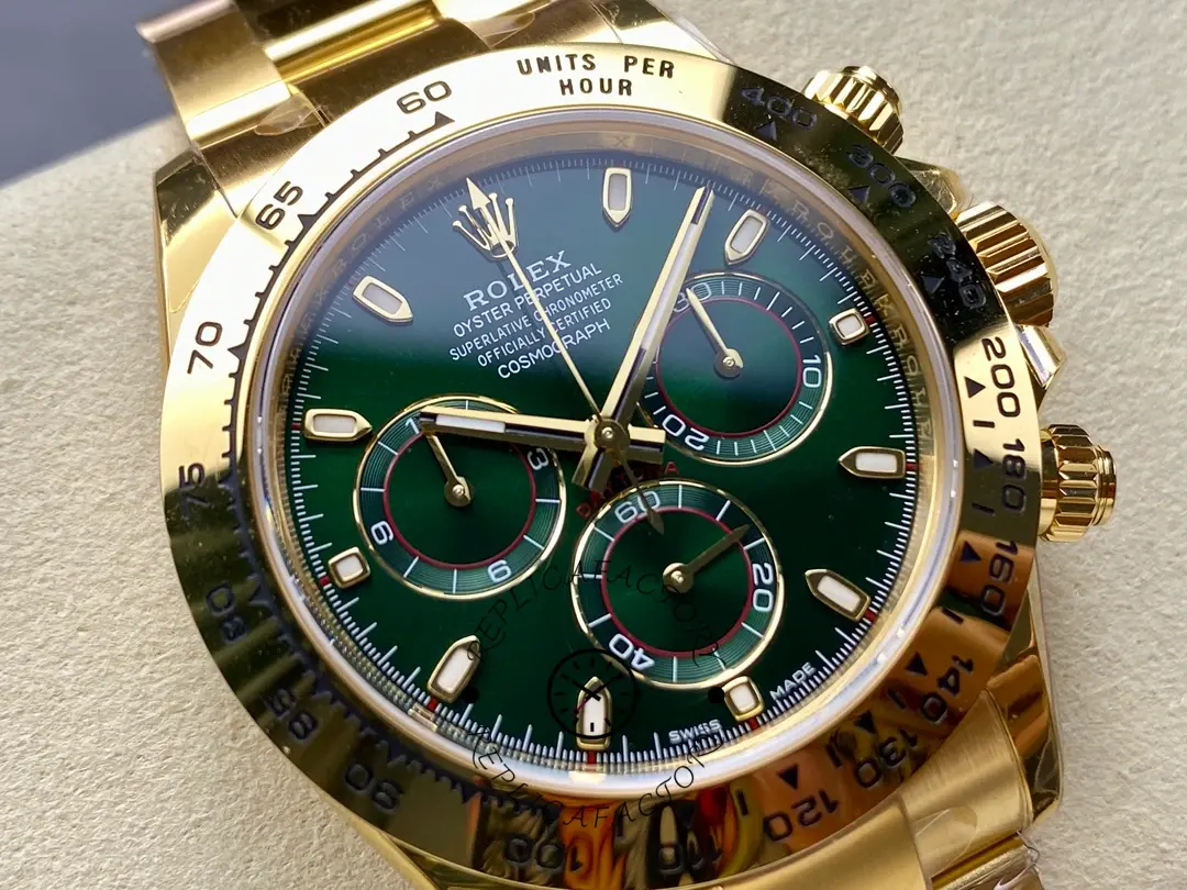 Close-up of Rolex Daytona 116508 showing green dial and gold case under light.