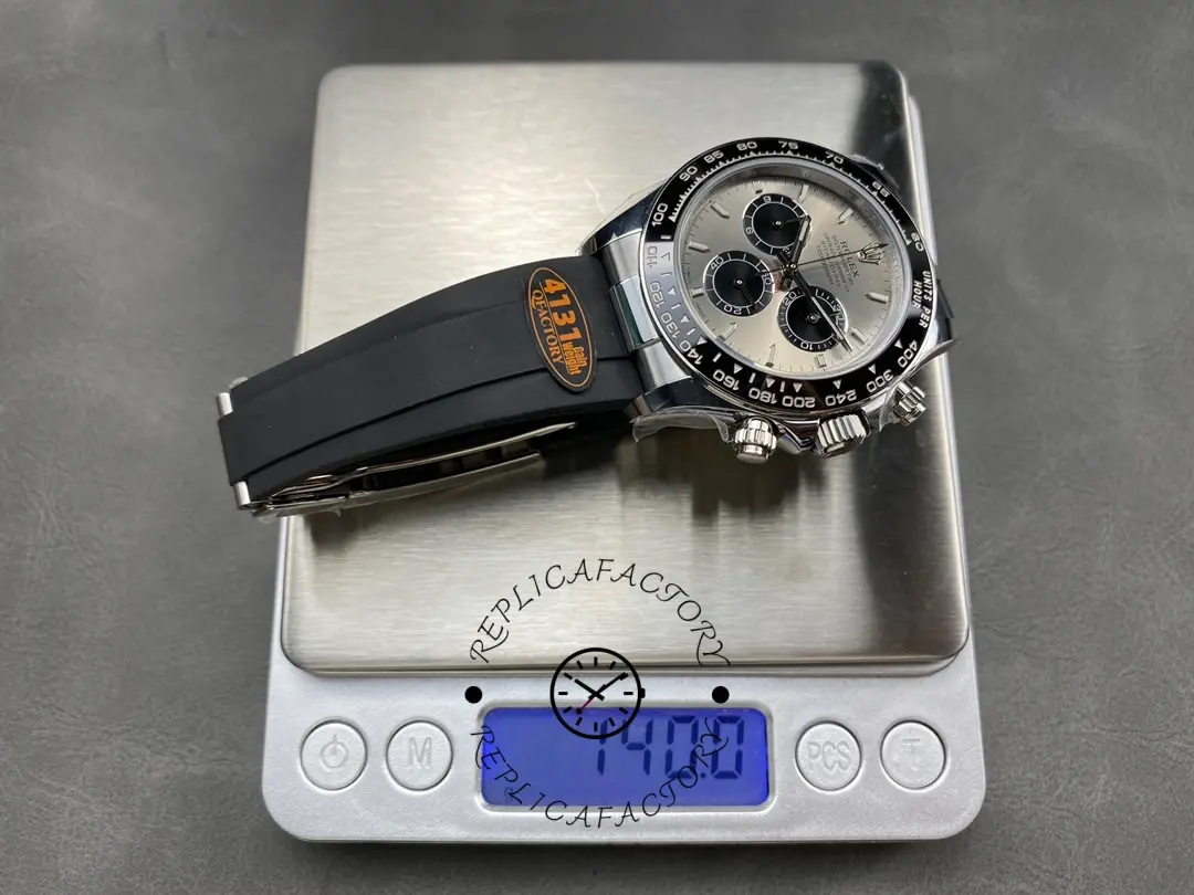Rolex Daytona 116519 on scale, weight display with black strap attached.