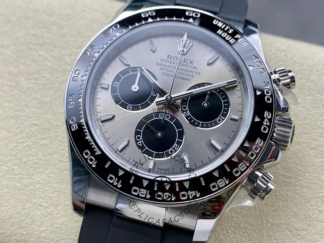 Rolex Daytona 116519 close-up, grey dial and bezel edge, strap tag visible.