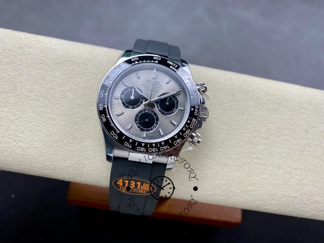 Rolex Daytona 116519 full watch view on cushion, grey dial and black strap.