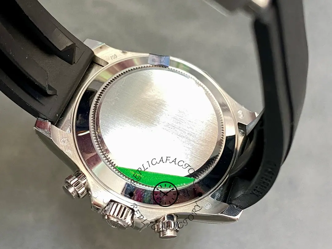 Case back close-up of Rolex Daytona 116599 showing protective green sticker on back.