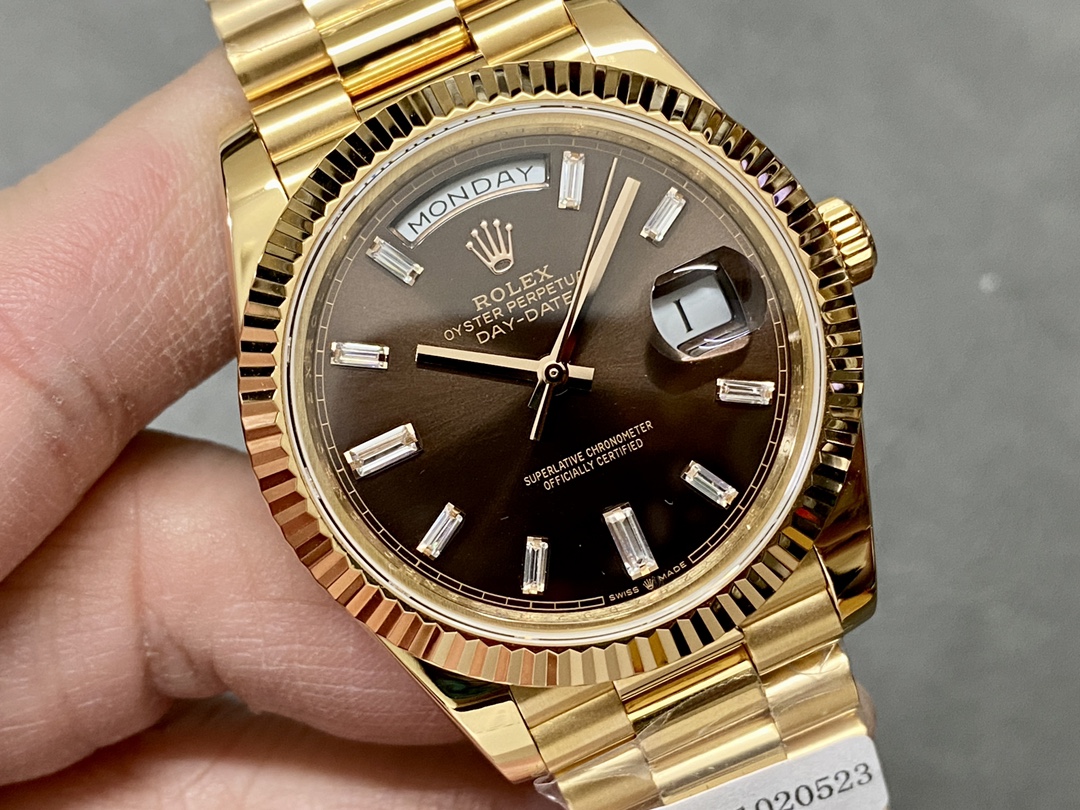Close-up of Rolex Day-Date 228238 with brown dial and baguette diamond hour markers under natural light.