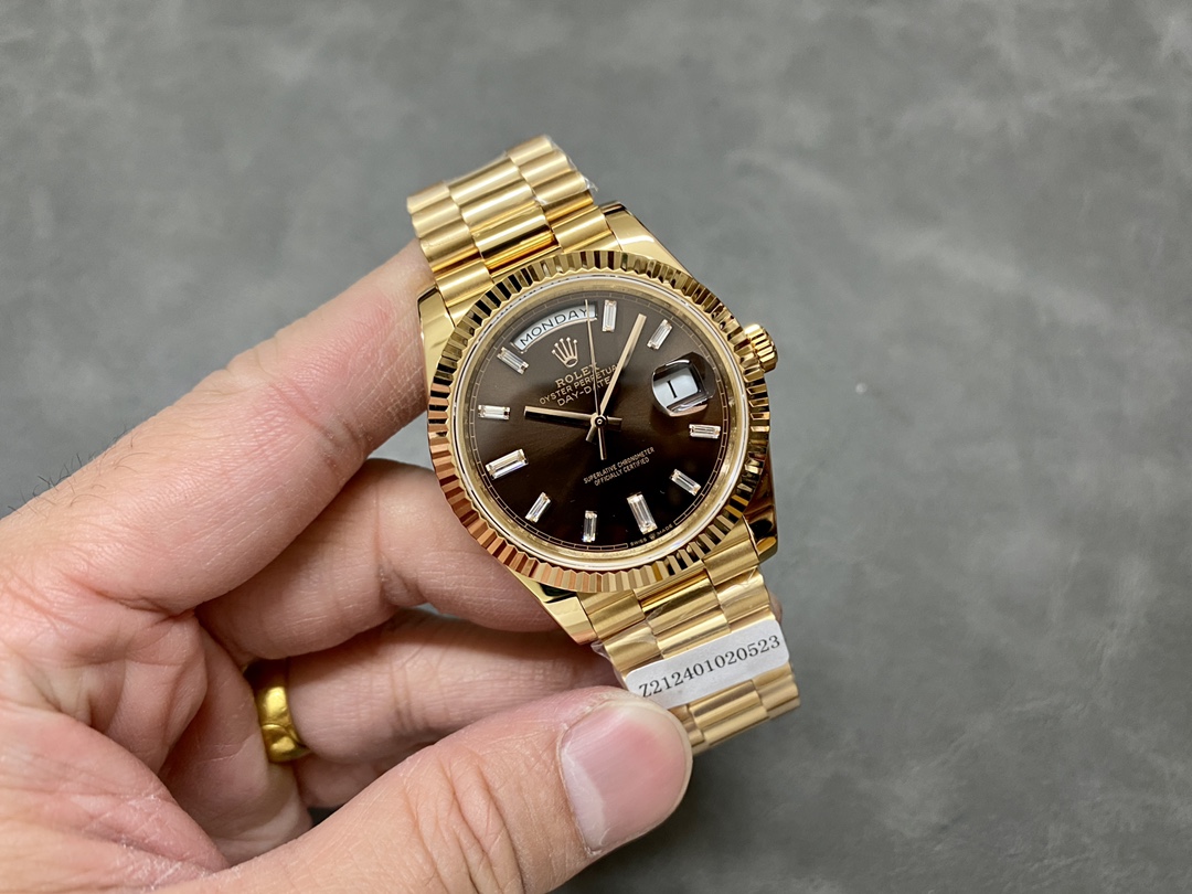 Handheld image of Rolex Day-Date 228238 showing overall case and bracelet design.