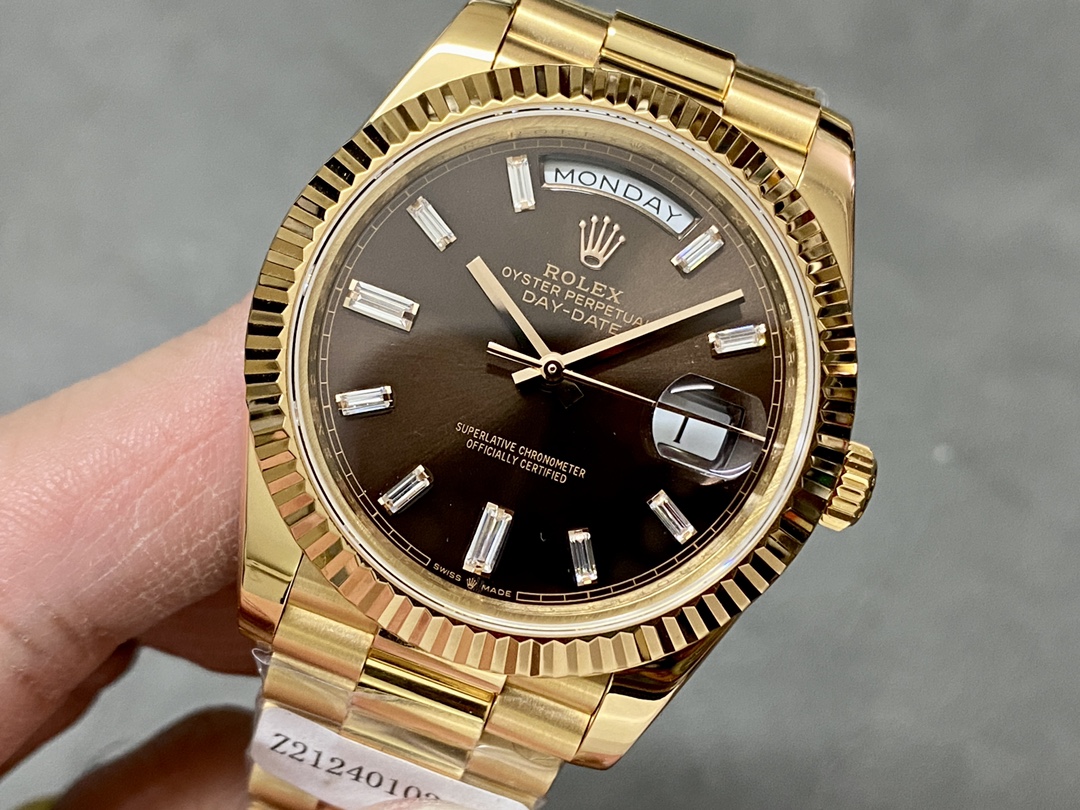 Close-up of the Rolex Day-Date 228238 brown dial with baguette diamond markers and date magnifier.