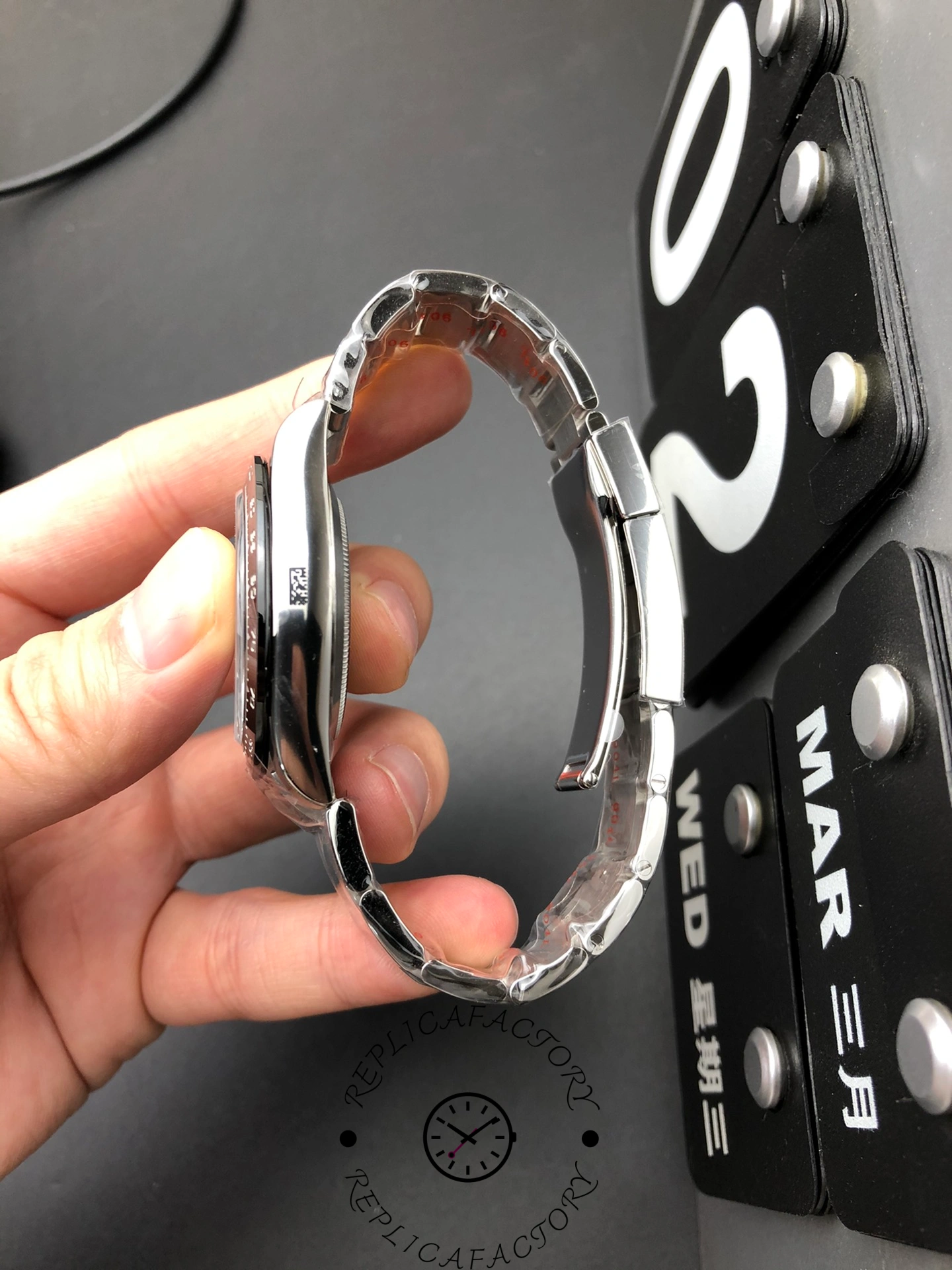 Reverse side view of Rolex Daytona 116500LN-0001 showing case thickness and bracelet curvature.