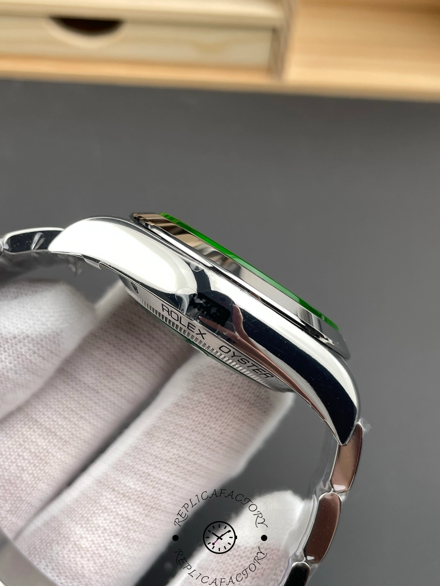 Left side of Rolex Milgauss 116400GV showing polished case curvature and crystal edge.