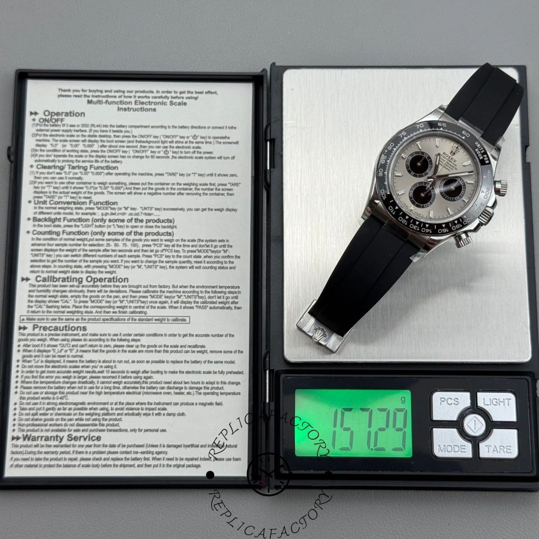 Rolex Cosmograph Daytona 126519LN-0006 on digital scale showing total weight of 157 grams.